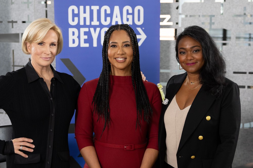 Mika Brzezinski, Liz Dozier, and Tatyana Ali in front of a Chicago Beyond sign.