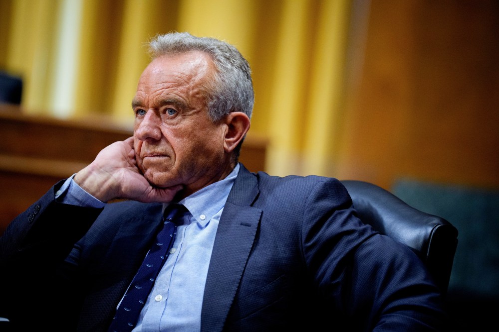 Robert F. Kennedy Jr sits with his hand under his chin