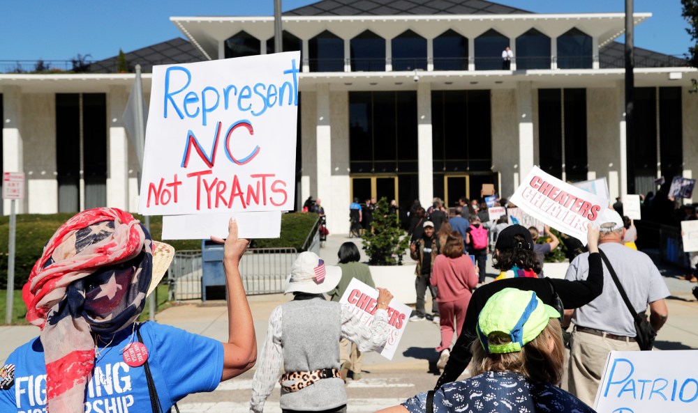 Demonstrators approach the Legislative Building during a rally protesting a proposed election redistricting map on Tuesday.