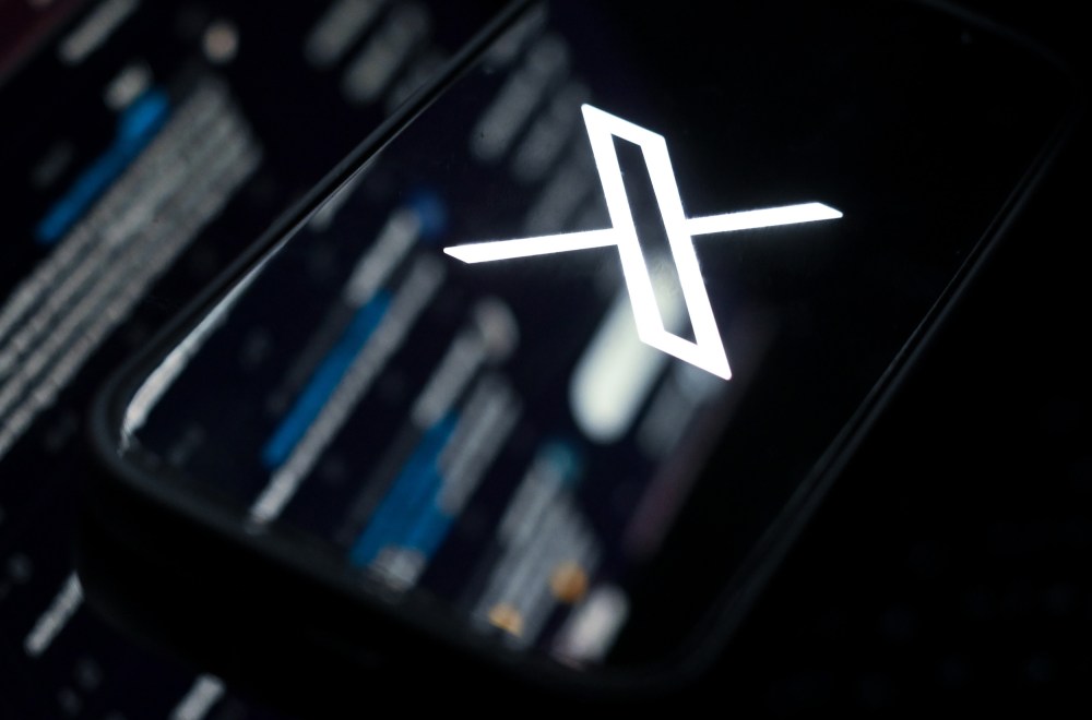 The web version of X mirrored onto a phone showing the X logo.