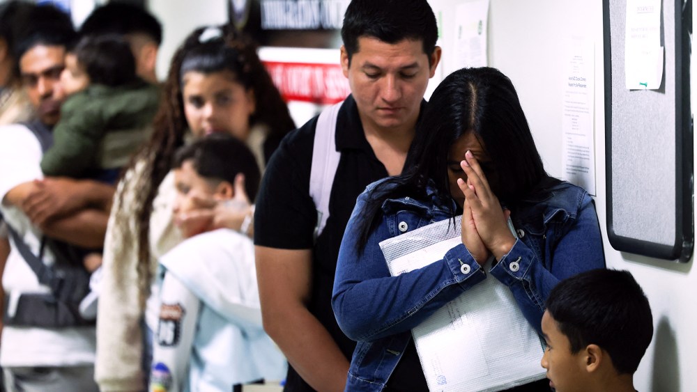People wait in line before their hearings at the New York Federal Plaza Immigration Court in New York City.