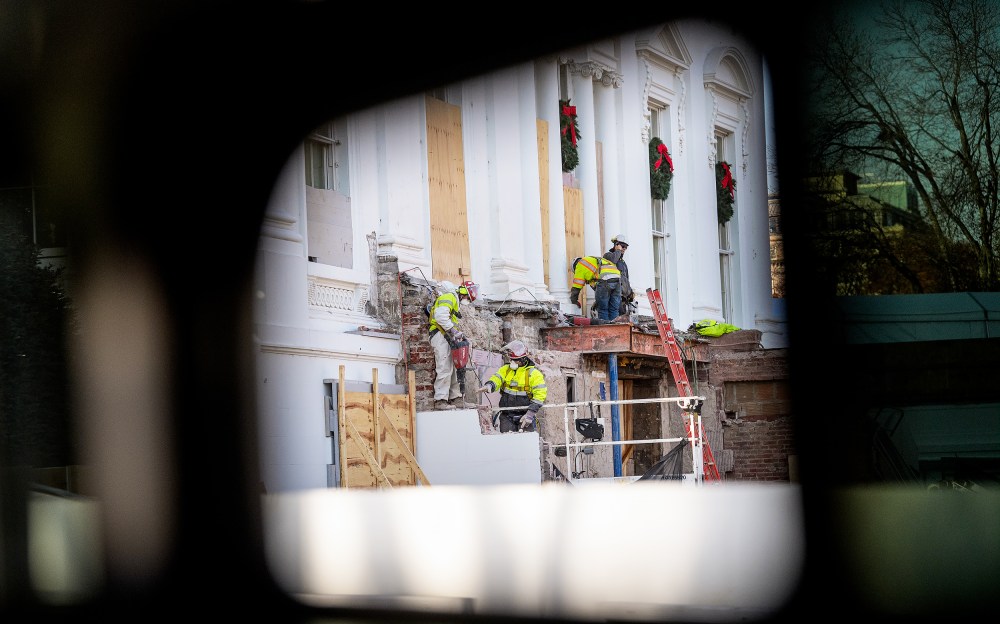 Construction workers take down material where the East Wing used to connect to the White House on Dec. 1.