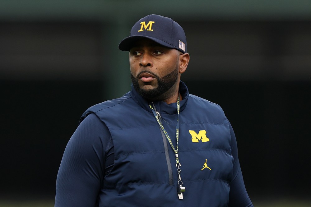 Former University of Michigan Sherrone Moore of the Michigan Wolverines observes practice prior to a game.