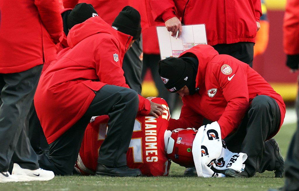 Patrick Mahomes #15 of the Kansas City Chiefs lays on the ground after sustaining an injury during the fourth quarter against the Los Angeles Chargers.