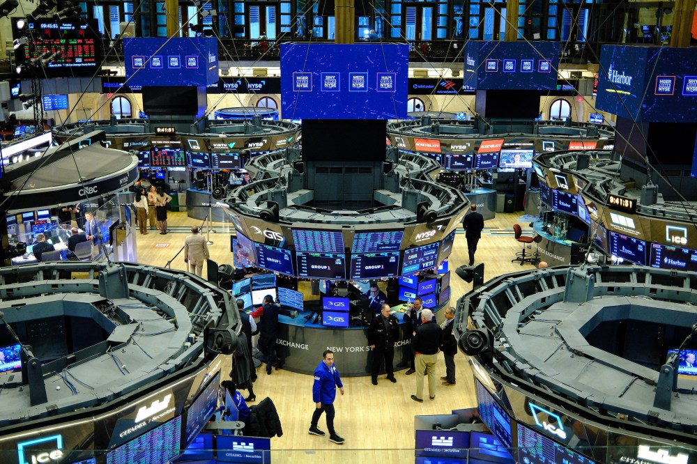 Traders work on the floor of the New York Stock Exchange at the opening bell in New York.