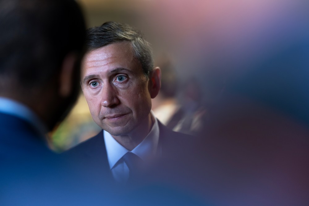 Ken Martin, chairman of the Democratic National Committee, partially obscured by reporters.