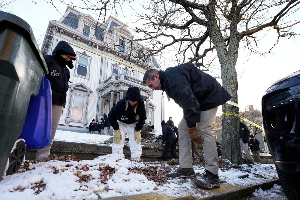 Members of the FBI Evidence Response Team search for evidence near Brown University.