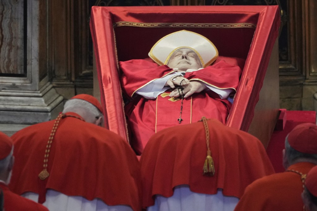 Cardinals pay their respects to the body of Pope Francis after his death.