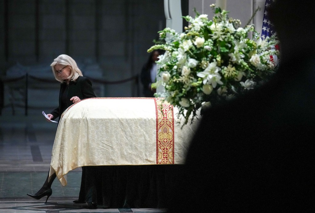 Former Rep. Liz Cheney walks past her father's casket.