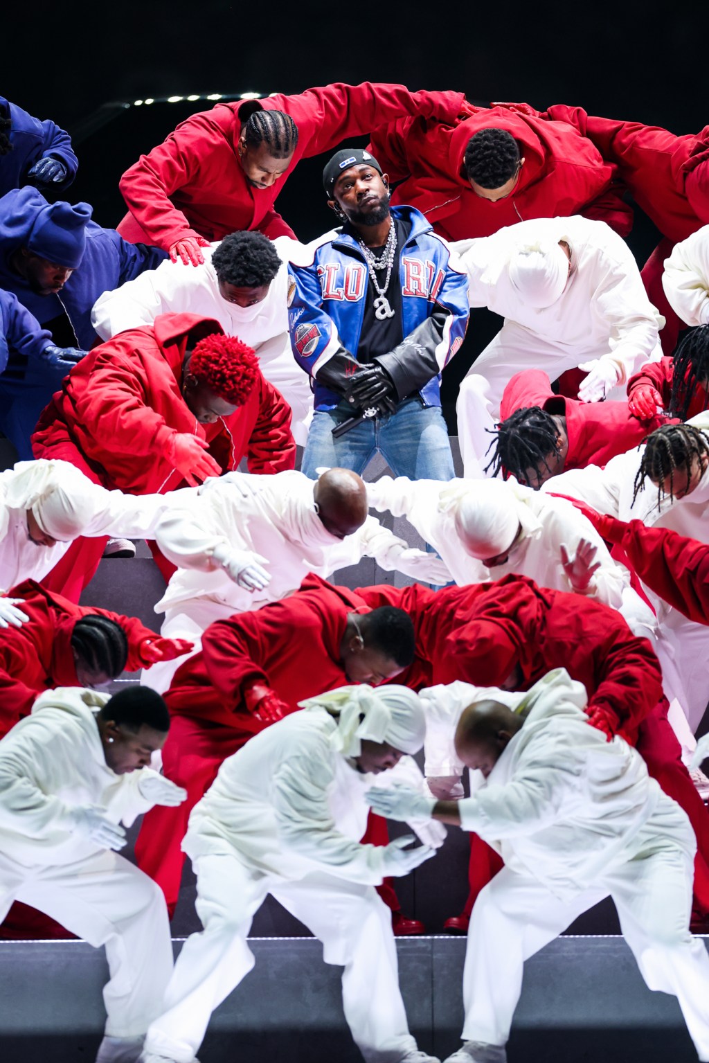 Kendrick Lamar performs, surrounded by people dressed in red, white and blue, at halftime during Super Bowl LIX.