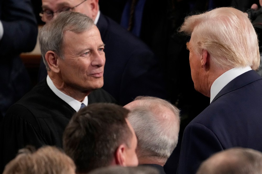 President Donald Trump greets Chief Justice John Roberts before he addresses a joint session of Congress at the U.S. Capitol.