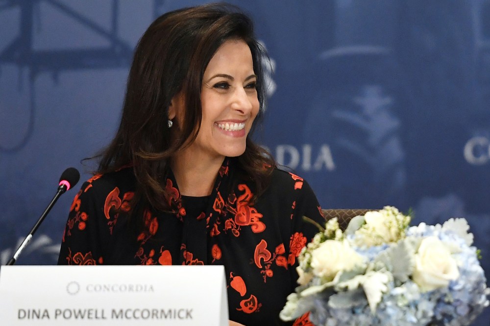 Dina Powell McCormick smiles.
