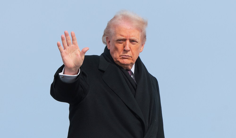 President Donald Trump waves as he boards Air Force One.
