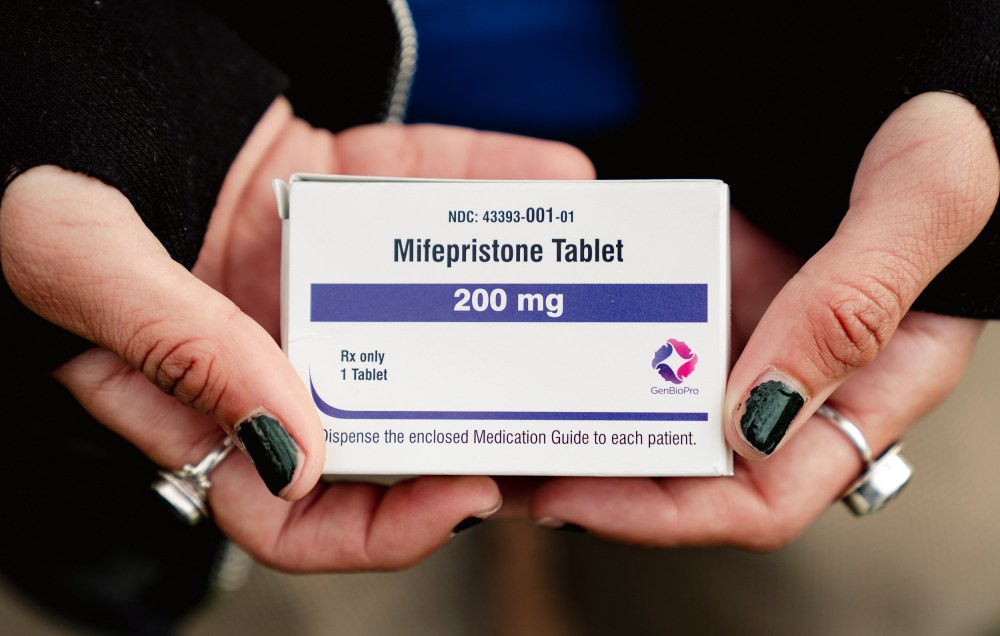 Trans man and abortion rights advocate Artemis Duffy holds a box of mifepristone on March 26, 2024 outside the U.S. Supreme Court.