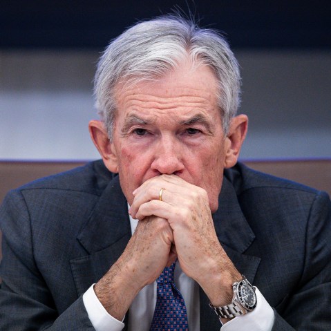 Jerome Powell sits with his hands clasped in front of his mouth.