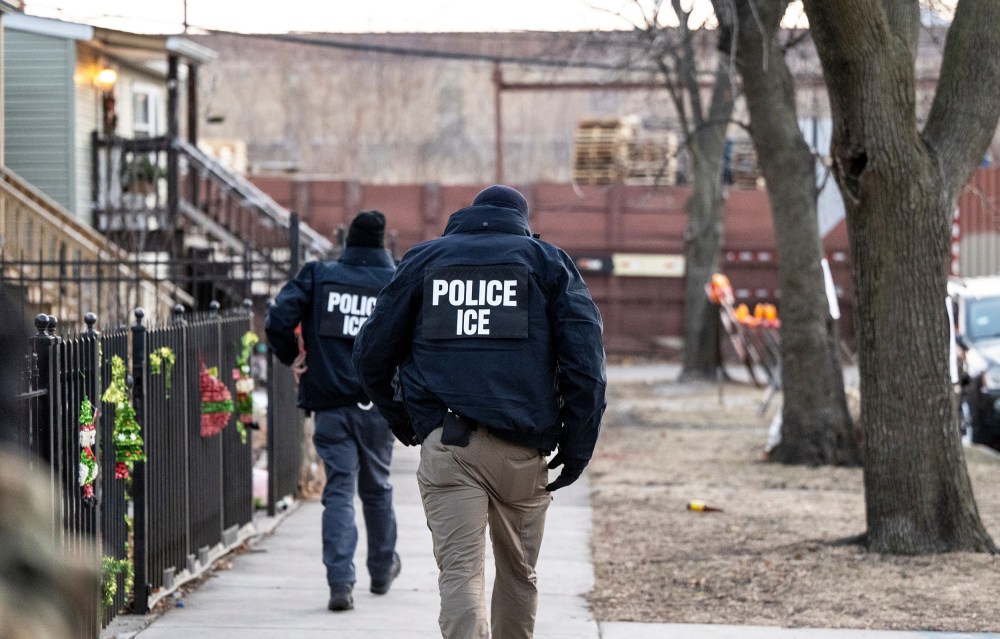 U.S. Immigration and Customs Enforcement agents walk down a street on Jan. 26, 2025, in Chicago.