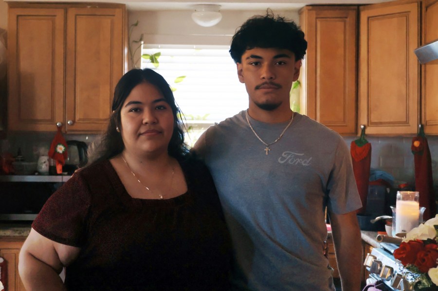 Arnoldo with his oldest sister, Maria, in their home.