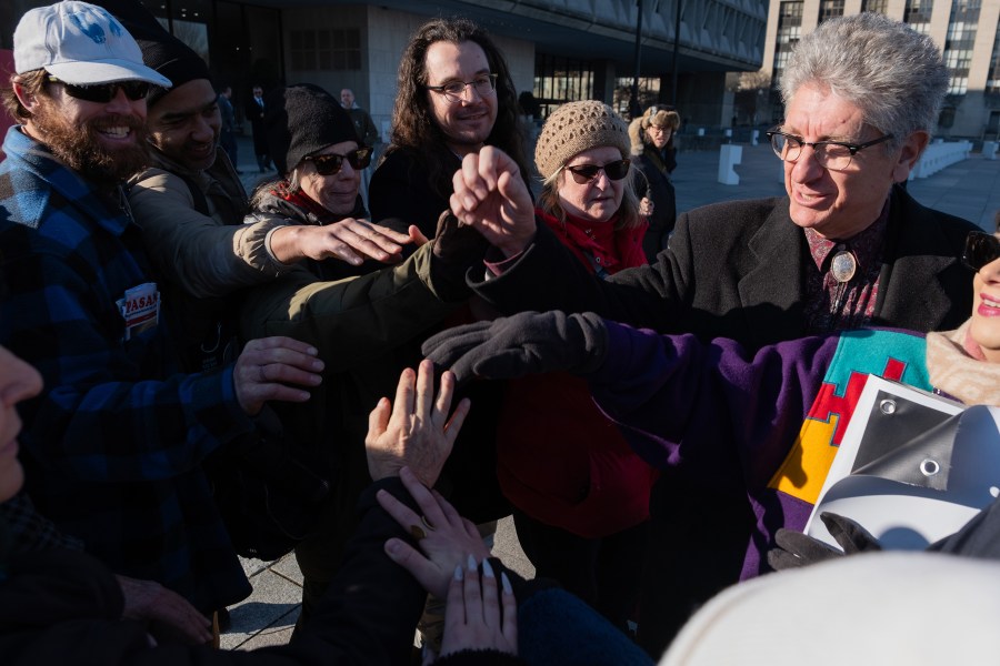 Pro-life activists put their hands together in the middle before cheering.
