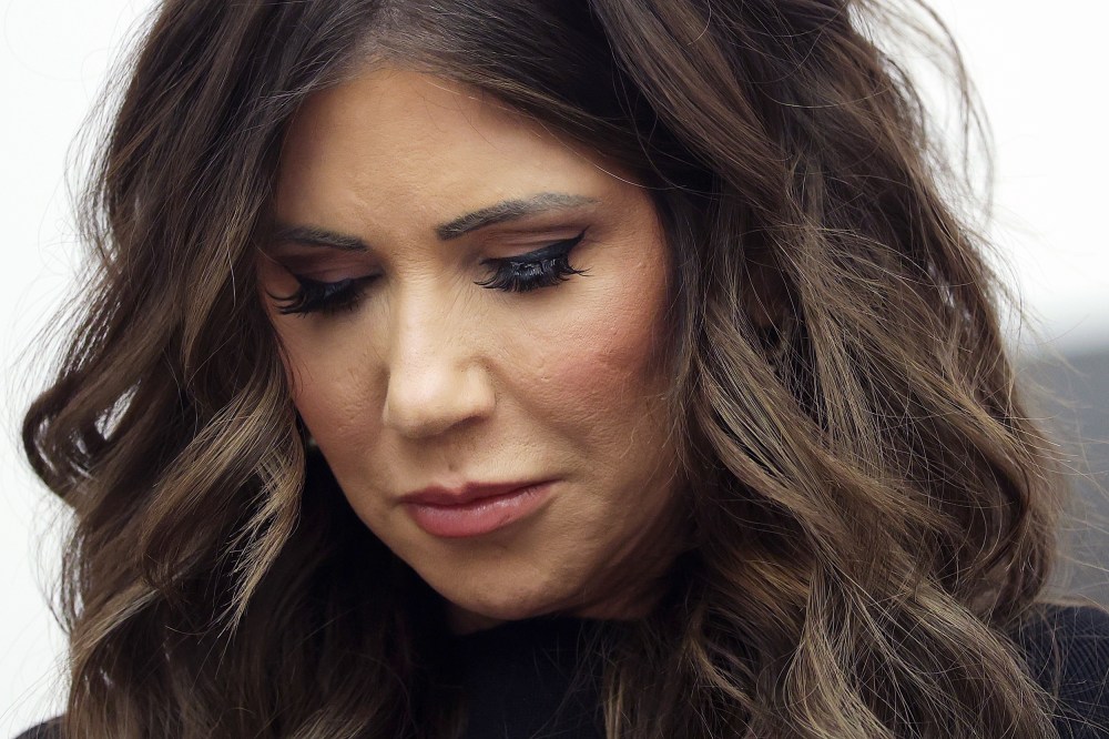 A very close-up photo shows Kristi Noem's face.