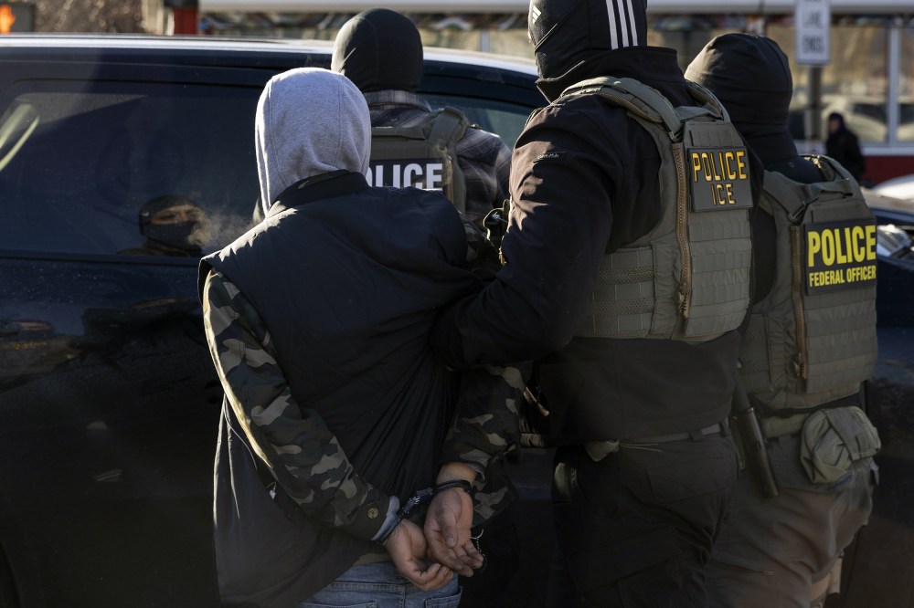A Federal Agent arrest a man after stopping and questioning him in the street during an Immigration Enforcement Operation on Jan. 14, 2026 in Minneapolis.