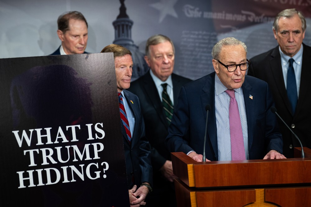 From left: Senator Ron Wyden, Senator Richard Blumenthal, Senator Dick Durbin, Senate Minority Leader Chuck Schumer, and Senator Jeff Merkley. On the left, a poster board that reads "WHAT IS TRUMP HIDING?"