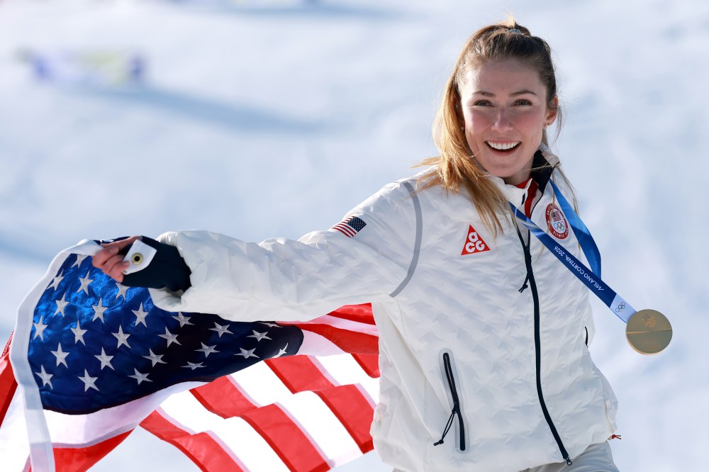 Gold medalist Mikaela Shiffrin of Team United States poses for a photo with a flag after the medal ceremony following the Women's Slalom Run on day twelve of the Milano Cortina 2026 Winter Olympics at Tofane Alpine Skiing Center on February 18, 2026 in Cortina d'Ampezzo, Italy