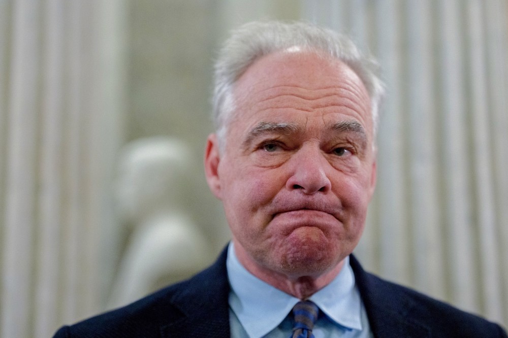 Tim Kaine looks in front of him with his lips pressed together.