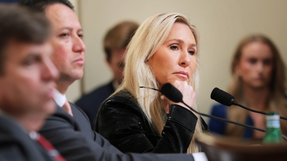 Marjorie Taylor Greene looks on as she sits along with other representatives.