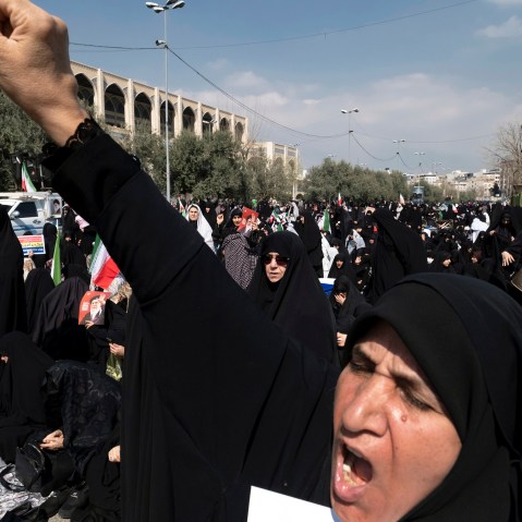 A veiled Iranian worshipper shouts slogans in Tehran.