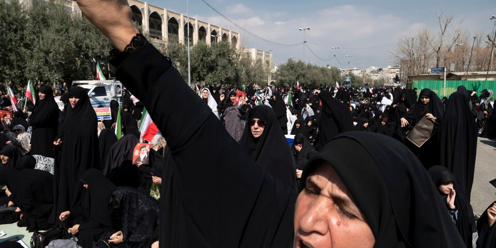 A veiled Iranian worshipper shouts slogans in Tehran.