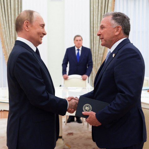 Vladimir Putin, left, shakes hands with Steve Witkoff.