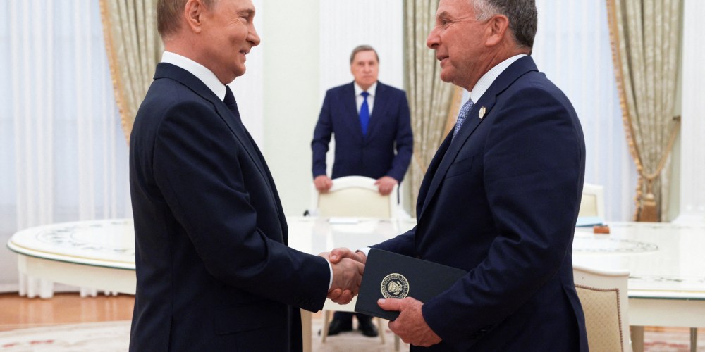 Vladimir Putin, left, shakes hands with Steve Witkoff.